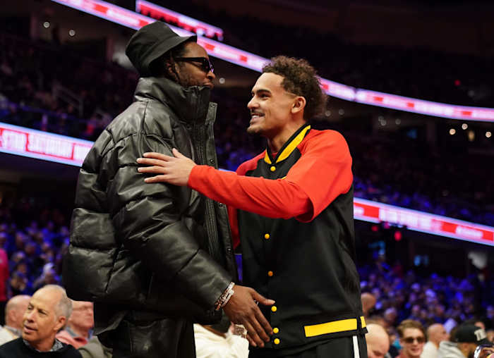 Feb 19, 2022; Cleveland, OH, USA; Atlanta Hawks guard Trae Young (11) greets recording artist 2-Chainz before the 3-Point Contest during the 2022 NBA All-Star Saturday Night at Rocket Mortgage Field House